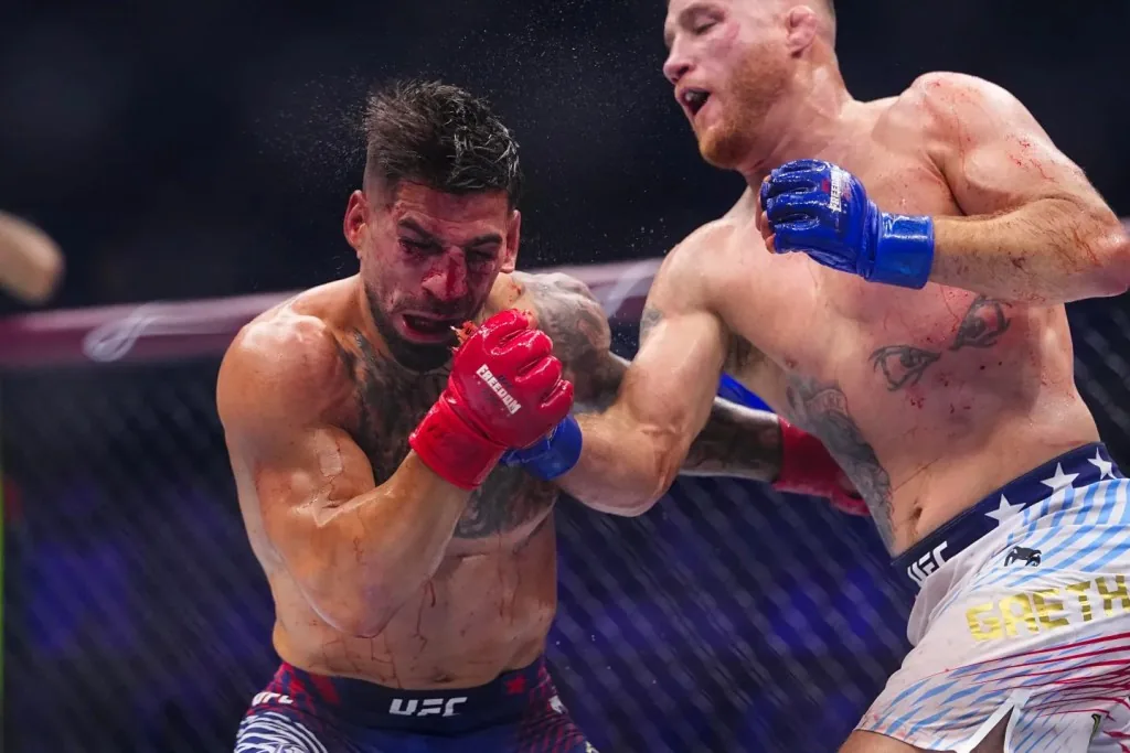 Dos luchadores de la UFC intercambian golpes en pleno combate dentro del octágono.