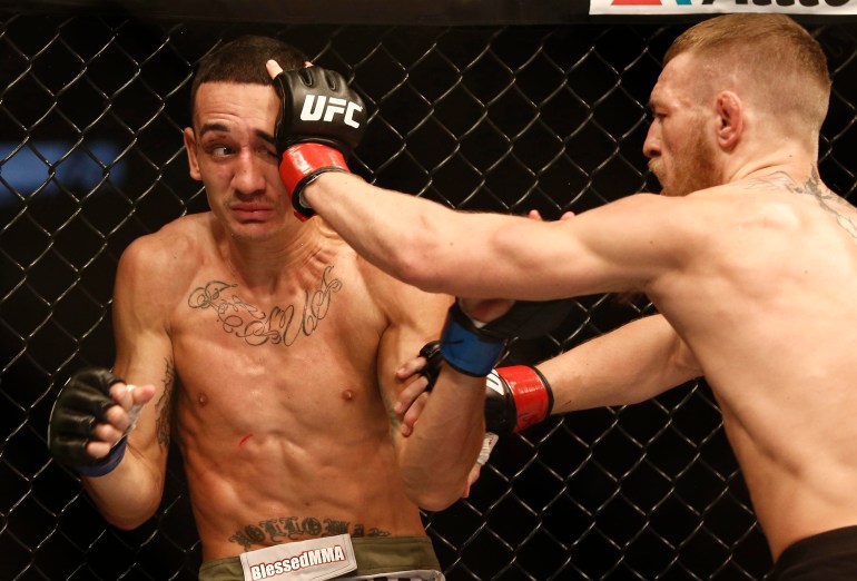Aug 17, 2013; Boston, MA, USA; Conor McGregor (black shorts) and Max Holloway (white shorts) fight during a UFC featherweight match at the TD Garden. McGregor won after three rounds by judges decision